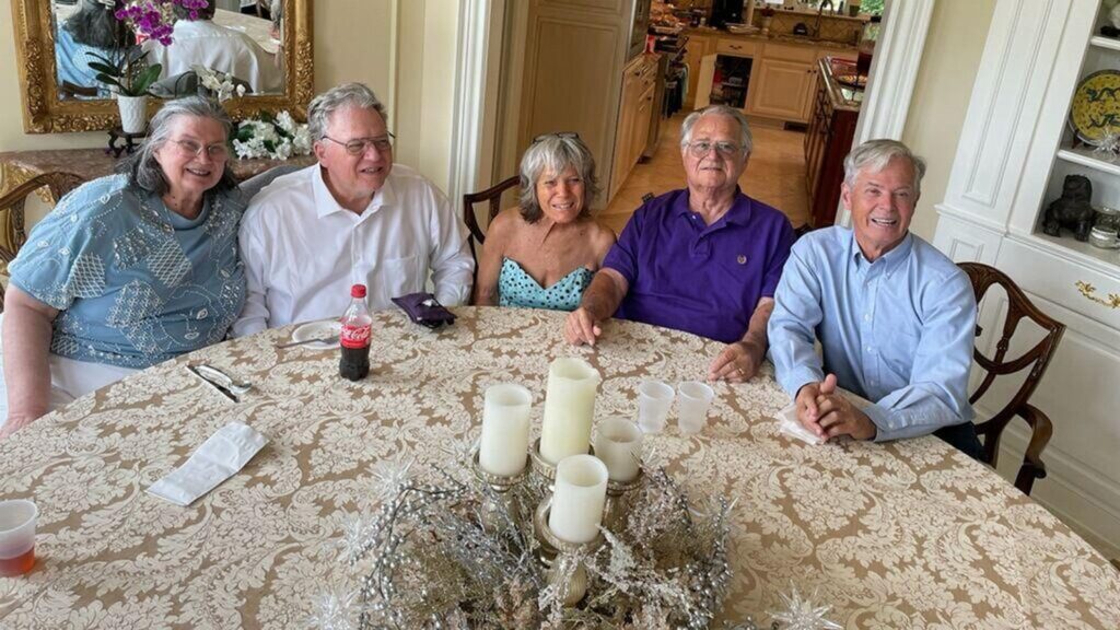 The five Struble siblings sitting around a table