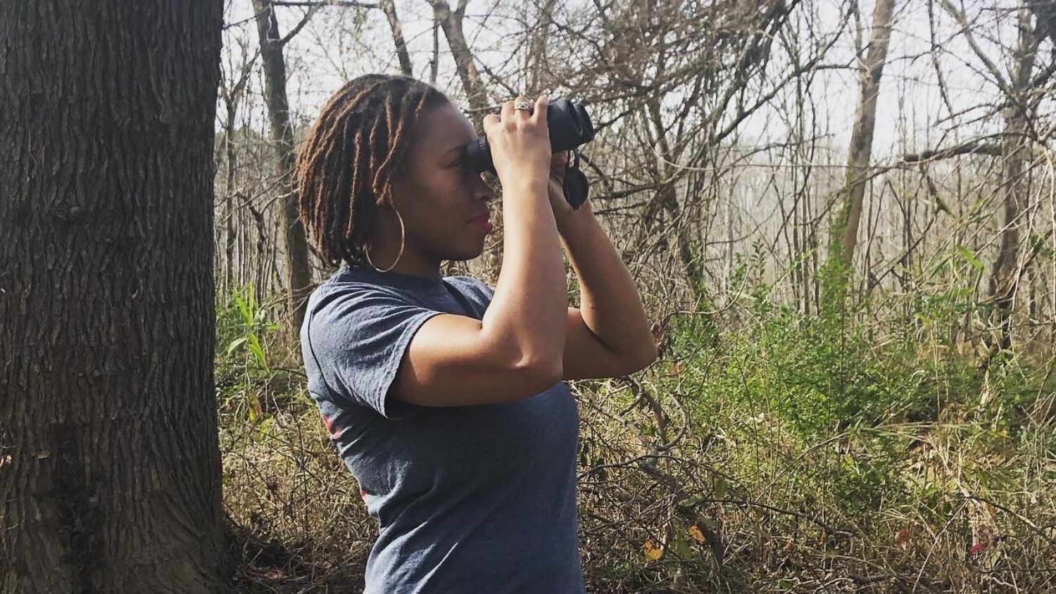 woman birding with binoculars