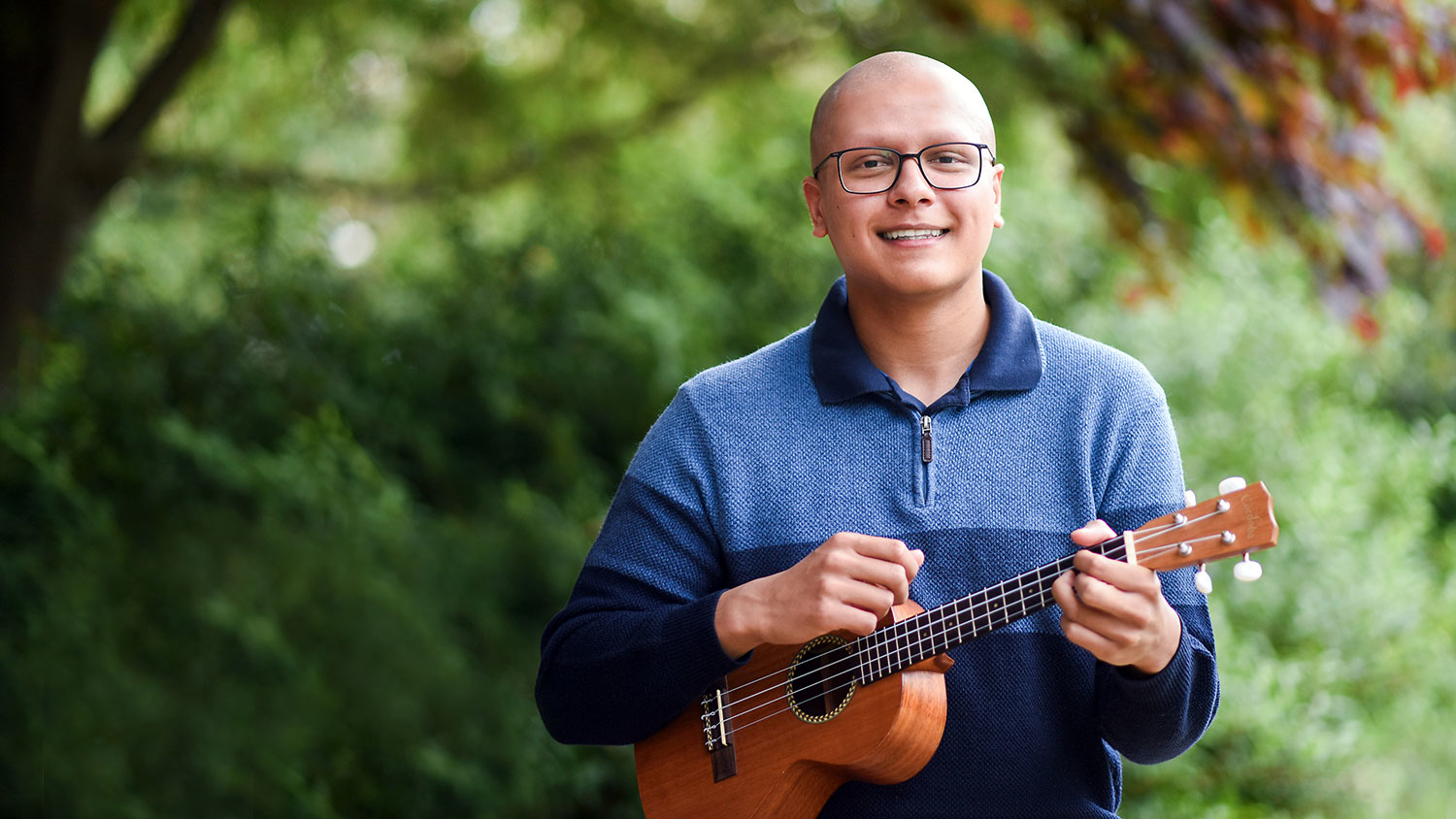 NC State student outside holding a ukulele