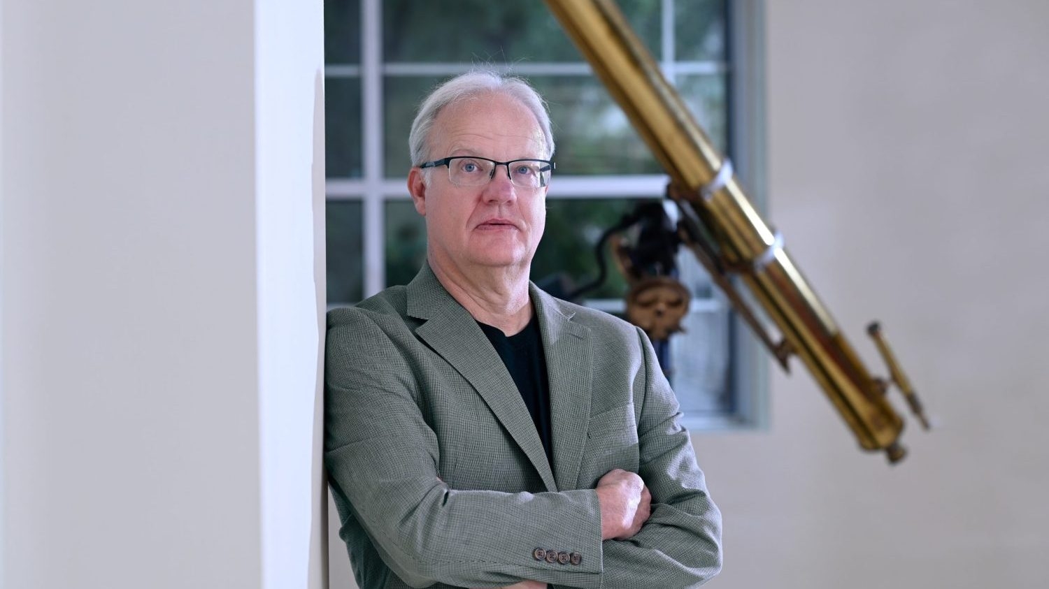 Dr. Schaefer leaning against a wall in Riddick Hall.