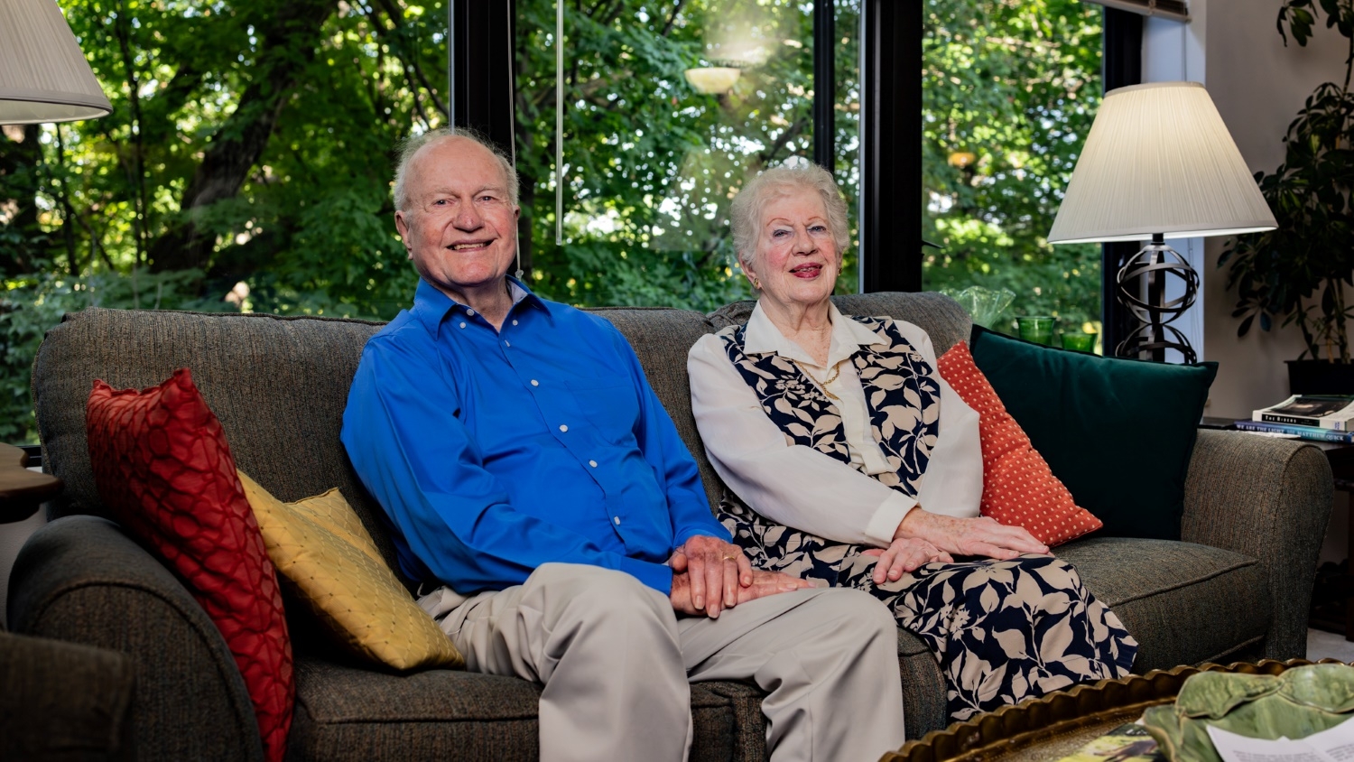 Lloyd and Genevieve Bostian sitting on their couch
