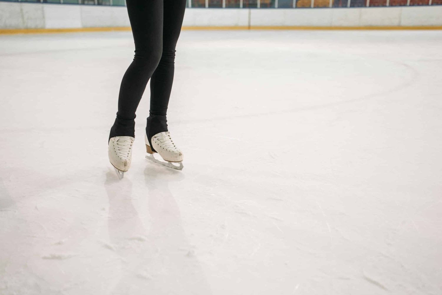 A person in Black Leggings Wearing Ice Skates